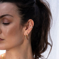 A woman showcasing her ear piercings